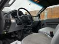Interior of a 2013 Ford F-650 showcasing the steering wheel dashboard and driver's seat with a focus on the control panel and gear shift