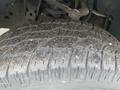 Close-up of a tire tread on a 2013 Ford F-150 showing diverse patterns and debris embedded in the grooves