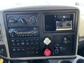 The dashboard of a 2013 International DuraStar 4300 featuring various controls gauges and a radio along with an air supply monitor