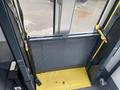 A 2017 Chevrolet Express with an open ramp leading into the interior of the vehicle, showcasing a yellow platform and a metal mesh barrier