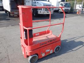 A red Snorkel TM 12 lift with a platform and safety guardrails on either side sitting on wheels