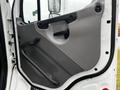 A 2006 Freightliner M2 112 truck door with a black handle and gray panel featuring a textured design and a lever for window adjustment