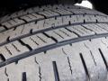 Close-up of a tread pattern on a tire of a 2016 Mercedes-Benz Sprinter showing deep grooves and textured rubber for traction