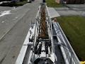 A top view of a 2008 Ford F-550 with a long ladder extending from its rear and various mechanical components visible along the ladder's length