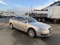 A silver 2006 Audi A6 parked at an angle showing its sleek design and alloy wheels