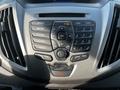 The dashboard control panel of a 2017 Ford Transit featuring buttons for radio media phone sound and a display screen