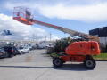 A 2008 JLG Boom Lift with an orange and white color scheme featuring a raised platform and extending arm designed for lifting personnel and equipment at height