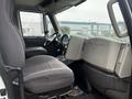 Interior of a 2013 International DuraStar showing the driver's seat and dashboard with controls and a steering wheel