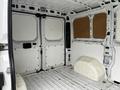 Interior of a 2018 RAM Promaster cargo van featuring white walls and a flat floor with a distinguishing wheel well on the right side