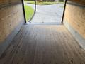 Interior view of a 2007 GMC W5500 18 foot cube van showing a wooden floor and open rear doors