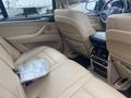 Interior of a 2009 BMW X5 featuring leather seats and a center console with climate controls and audio settings