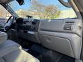 The interior of a 2006 Ford F-550 showing the dashboard with controls and seating area