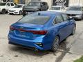 A blue 2021 Kia Forte parked with its rear and side visible showcasing sleek lines and modern design features