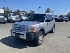 A silver 2006 Land Rover LR3 is parked with a clean exterior and distinctive front grille showcasing the brand logo
