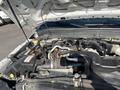The image shows the open hood of a 2015 Ford F-450 SD revealing the engine compartment with various components like hoses wires and a battery visible