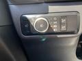 A control panel in a 2023 Ford Bronco Sport featuring various buttons and a dial for lights and settings