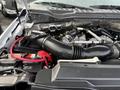 Engine compartment of a 2017 Ford F-450 Super Duty showcasing the air intake and battery with various engine components visible