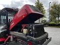 A red 2012 Toro Groundsmaster with the engine hood lifted revealing the radiator and engine components