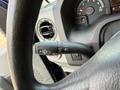 Close-up of the steering wheel controls of a 2011 Ford Econoline showing the wiper and turn signal levers alongside the dashboard gauges