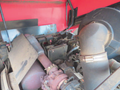 A close-up view of the engine compartment of a 2013 Toro Grounds Master 5910 showing various mechanical components and tubing