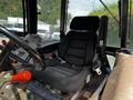Interior view of a 2011 Kubota M8540D tractor showing the driver's seat with armrests and controls visible around it