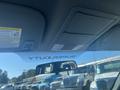 Interior view of a 2014 Ford F-250 SD with overhead storage and a visibility of the front windshield featuring the words SUPER DUTY in the driver's area