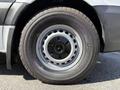 A close-up of a black tire with a silver five-spoke wheel featuring a centered Mercedes-Benz logo
