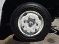 Close-up of a white wheel from a 2019 Freightliner MT45 showing bolts and a Bridgestone tire with the number P235/80R22.5
