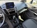 Interior view of a 2021 Ford Transit Connect showcasing the dashboard center console with a touchscreen display gear shift and controls