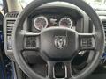 Steering wheel of a 2019 RAM 1500 Classic featuring control buttons and an emblem of a ram in the center