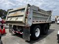 A 2013 K-Line 16 foot steel tandem pony 17 ton dump trailer featuring Air Weigh technology with a weathered exterior and noticeable wear on the rear panel