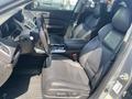 Interior view of a 2017 Acura TLX featuring black leather seats a center console with controls and a steering wheel