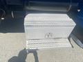A silver diamond plate tool box attached to the side of a 2008 Peterbilt 340 truck with a drop-down door for easy access