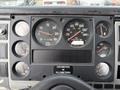 Dashboard of a 1998 Freightliner FL80 featuring multiple gauges including speedometer, RPM, fuel, and volt meters along with an odometer display