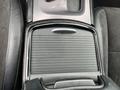 A close-up view of the center console of a 2022 Dodge Charger showing a sleek, black storage compartment with a textured surface