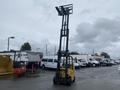 A yellow 2010 Hyster S80XLBCS forklift with an extended mast and forks raised is positioned in the foreground