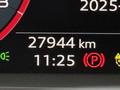 A digital display showing the mileage of 27944 km and the time as 11:25 with various indicator lights illuminated