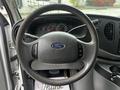 Steering wheel of a 2008 Ford Econoline with dashboard indicators and controls visible in the background