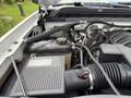 The engine compartment of a 2017 Chevrolet Silverado 1500 showing the air intake, coolant reservoir, and various hoses and components