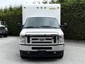 A 2021 Ford E-450 box truck in silver with a flat front and prominent grille featuring the Ford logo