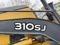 A close-up of a John Deere 310SJ wheel loader showing the model number 310SJ prominently displayed on the side of the machine