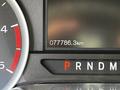 A close-up of the dashboard of a 2018 Ford F-550 displaying the odometer reading of 077786.3 km and the gear selector showing P for park