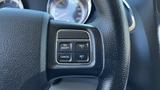 Close-up of the steering wheel controls in a 2016 Dodge Grand Caravan featuring buttons for cruise control functions like on off resume cancel and set