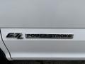 A close-up of a white 2018 Ford F-550 badge displaying 6.7L Power Stroke Turbo Diesel text