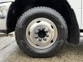A close-up of a silver wheel and tire from a 2013 RAM 3500 featuring a Wrangler Goodyear tire and a five-bolt pattern on the wheel rim