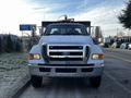 A 2011 Ford F-750 truck with a white exterior and chrome grille facing directly towards the viewer