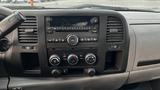 Dashboard of a 2013 Chevrolet Silverado 1500 featuring a central audio system with knobs and buttons for control