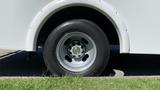 Close-up of a wheel and tire of a 2011 Chevrolet Express with a silver rim and black tire visible