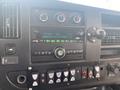 Dashboard of a 2016 Chevrolet Express featuring a radio display climate controls and various buttons for vehicle functions