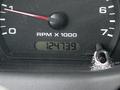 Close-up of a 2010 Ford Ranger's dashboard displaying the RPM gauge and odometer reading 124739 miles
